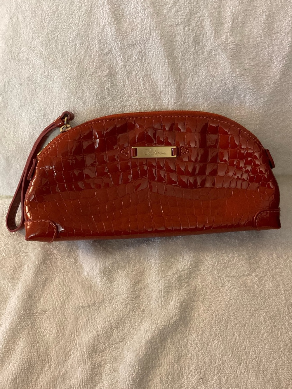 Cole Haan croc embossed paten wristlet